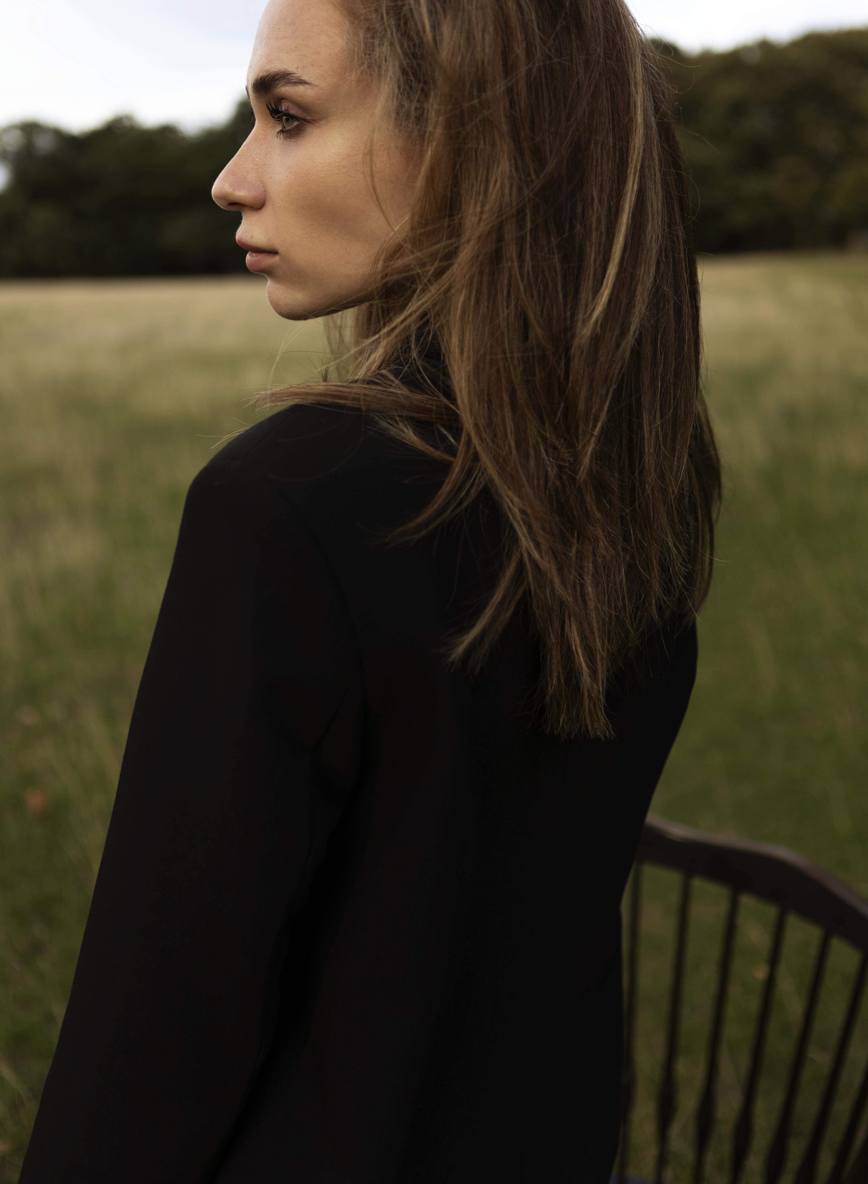 Girl stands in a field.