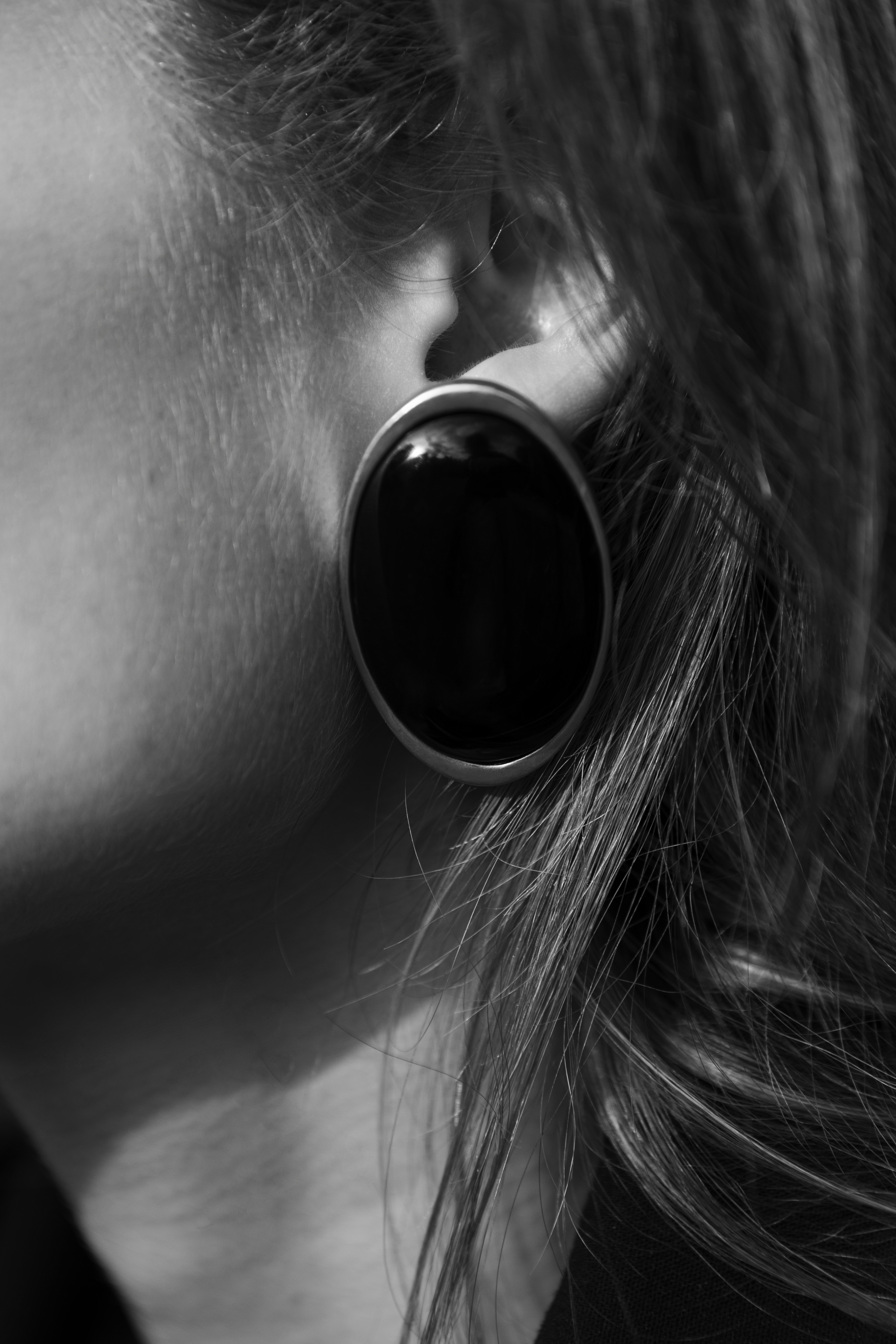 A close up black and white shot or an earing